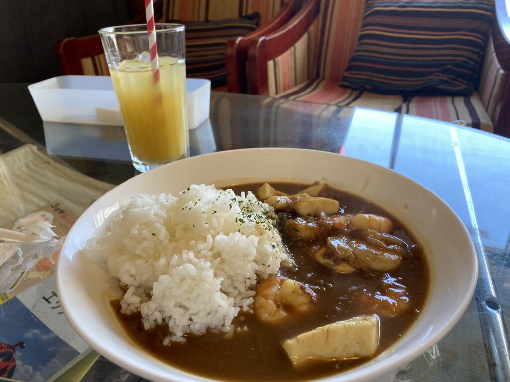 直島温泉⑩：島カフェ「コンニチハ」　コンニチハカレーとオレンジジュースの写真